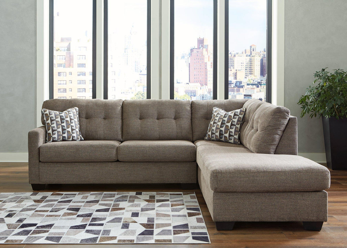 Ashley Furniture Mahoney 2-Piece Sleeper Sectional with Chaise, gray fabric with plush cushions and modern design.