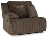 Ashley Furniture Top Tier reclining sectional sofa with chaise, featuring plush cushions and a modern design in a spacious living room setting.