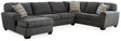 Ashley Furniture Ambee 3-piece sectional with chaise, featuring plush cushions and modern design in a cozy living room setting.