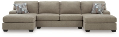 Ashley Furniture Newellen sectional with double chaise, showcasing plush upholstery and modern design in a spacious living room.