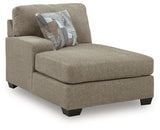 Ashley Furniture Newellen sectional with double chaise, showing a spacious L-shaped sofa with plush cushions and neutral upholstery.