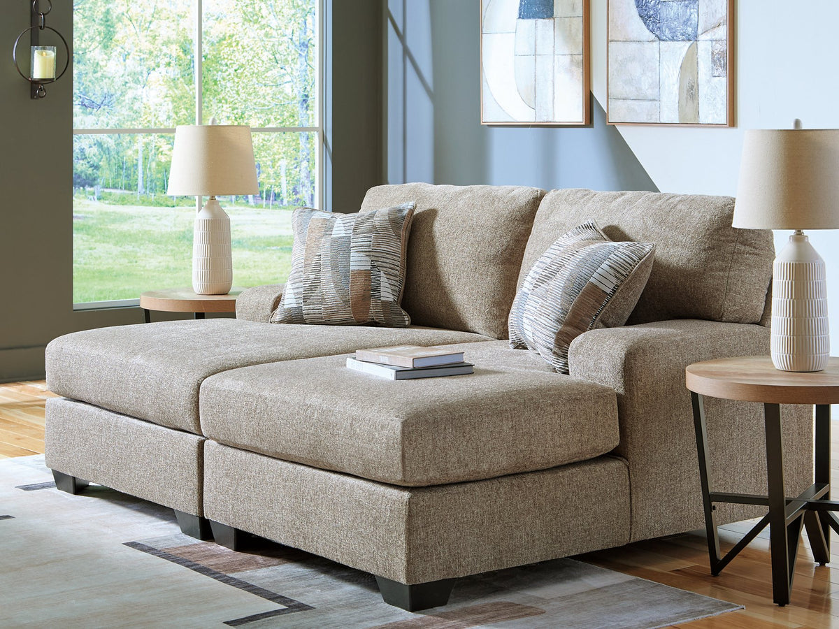 Ashley Furniture Newellen Super Chaise sectional with plush cushions and modern design, shown in a cozy living room setting.