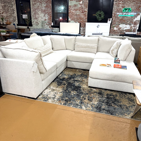 Ashley Furniture Pebblebrook 5-piece corner sectional with ottoman, featuring plush cushions and modern fabric upholstery.