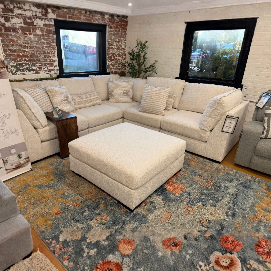 Ashley Furniture Pebblebrook 5-piece modular corner sectional with plush cushions and neutral fabric upholstery.