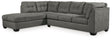 Ashley Furniture Pitkin 2-piece sectional with chaise, beige fabric, modern design, with cushions and wooden legs.