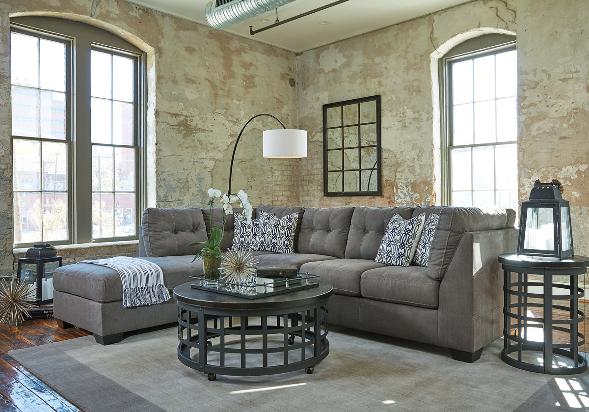 Ashley Furniture Pitkin 2-piece sectional with chaise, featuring plush cushions and modern design in a cozy living room setting.