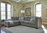 Ashley Furniture Pitkin 2-piece sectional with chaise, showing plush fabric upholstery and modern design in a spacious living room setting.