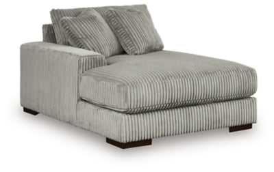 Ashley Furniture Lindyn sectional with chaise showcasing beige fabric, plush cushions, and a modern design in an angled view.