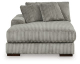 Ashley Furniture Lindyn sectional with chaise, showcasing beige fabric upholstery and plush cushions in a modern living room setting.