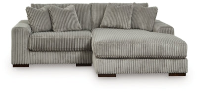 Ashley Furniture Lindyn sectional with chaise, featuring plush fabric upholstery and modern design in a spacious living room setting.