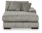 Ashley Furniture Lindyn sectional with chaise, beige fabric, plush cushions, and modern design in a cozy living room setting.
