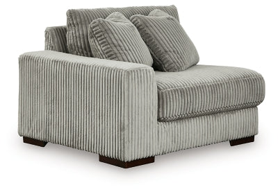 Ashley Furniture Lindyn sectional with chaise, showing a modern fabric sofa with angled design and plush cushions.
