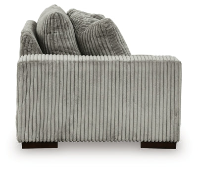 Ashley Furniture Lindyn sectional with chaise, featuring plush cushions and modern design, shown from the side.