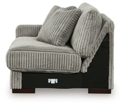 Ashley Furniture Lindyn sectional with chaise, featuring a modern design and plush upholstery in a spacious living room setting.