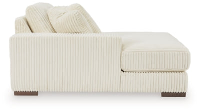 Ashley Furniture Lindyn sectional with chaise, showing light gray fabric, plush cushions, and modern design in a living room setting.