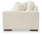 Ashley Furniture Lindyn sectional with chaise showing a modern fabric sofa with cushions and a side view in a living room setting.