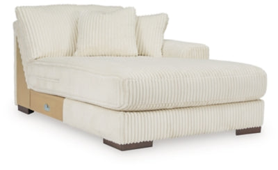 Ashley Furniture Lindyn sectional with chaise, showing a modern fabric sofa with a chaise lounge in a well-lit living room.