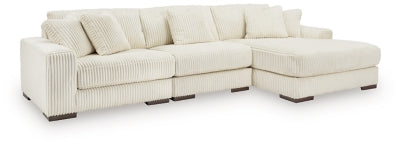 Ashley Furniture Lindyn sectional with chaise showing plush fabric, modern design, and spacious seating in a neutral tone.