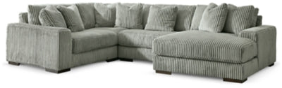 Ashley Furniture Lindyn sectional with chaise in neutral fabric, featuring plush cushions and modern design.
