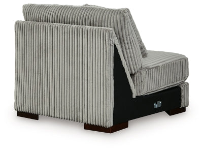 Ashley Furniture Lindyn sectional with chaise, showing plush fabric upholstery and back cushions in a cozy living room setting.