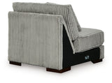 Ashley Furniture Lindyn sectional with chaise, showing plush fabric upholstery and back cushions in a cozy living room setting.