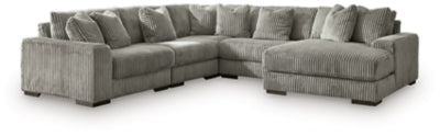 Ashley Furniture Lindyn sectional with chaise, featuring plush fabric and modern design, shown in a spacious living room setting.