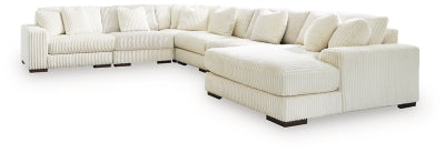 Ashley Furniture Lindyn sectional with chaise, featuring plush fabric and modern design, shown in a spacious living room setting.