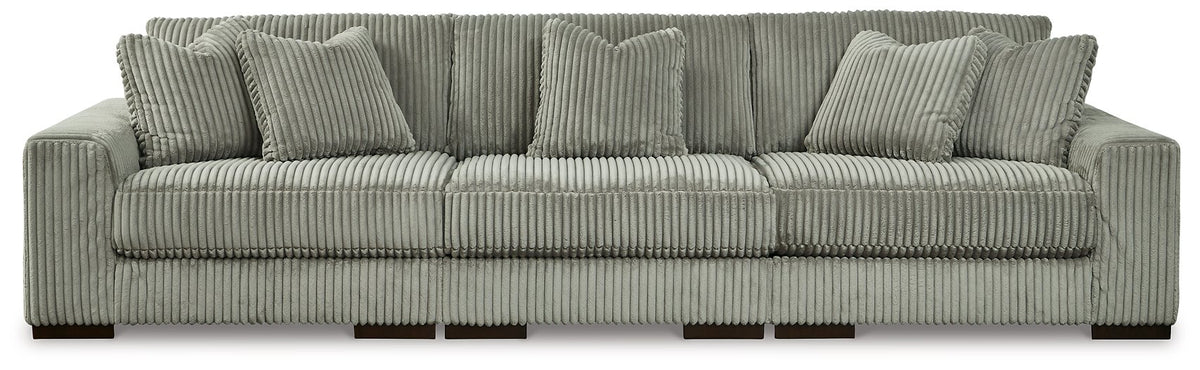 Ashley Furniture Lindyn sectional sofa with plush cushions and neutral fabric, shown in a spacious living room setting.
