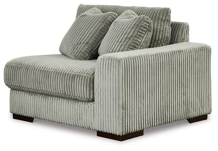 Ashley Furniture Lindyn sectional sofa with plush cushions and modern design, shown in a spacious living room setting.