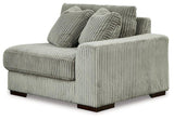 Ashley Furniture Lindyn sectional sofa with plush cushions and modern design, shown in a spacious living room setting.