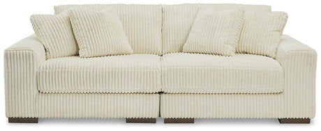 Ashley Furniture Lindyn sectional sofa with plush cushions and neutral fabric, showcasing a modern L-shaped design in a living room setting.