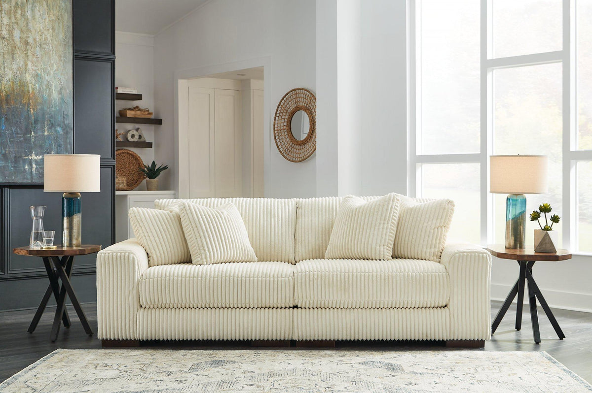 Ashley Furniture Lindyn sectional sofa with plush cushions and modern design, shown in a spacious living room setting.