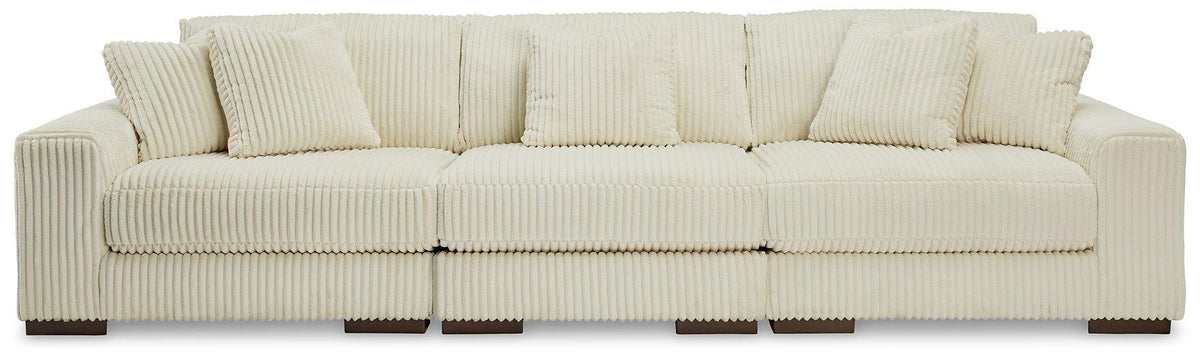 Ashley Furniture Lindyn sectional sofa with plush fabric and modern design, featuring multiple seating sections and cozy cushions.