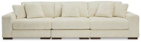 Ashley Furniture Lindyn sectional sofa with plush fabric and modern design, featuring multiple seating sections and cozy cushions.
