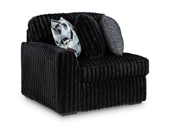 Ashley Furniture Midnight-Madness sectional sofa shown from an angled view, featuring plush cushions and modern design.