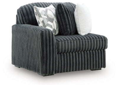Ashley Furniture Midnight-Madness sectional sofa in dark fabric, shown from an angled view highlighting its modern design.