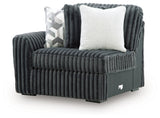Ashley Furniture Midnight-Madness sectional sofa shown from an angle, upholstered in dark fabric with plush cushions and modern design.