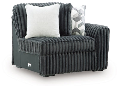 Ashley Furniture Midnight-Madness sectional sofa with dark upholstery and modern design, shown from an angled side view.