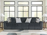 Ashley Furniture Midnight-Madness sectional sofa with dark fabric, featuring multiple seating sections and plush cushions.