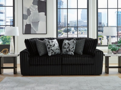 Ashley Furniture Midnight-Madness sectional sofa with plush cushions and modern design, shown in a cozy living room setting.