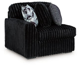 Ashley Furniture Midnight-Madness sectional sofa in dark fabric, shown from an angled view highlighting its modern design.