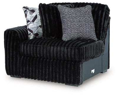 Ashley Furniture Midnight-Madness sectional sofa viewed from an angle, showcasing its spacious design and dark upholstery.