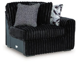 Ashley Furniture Midnight-Madness sectional sofa in a modern living room, showing the L-shaped design and plush upholstery.