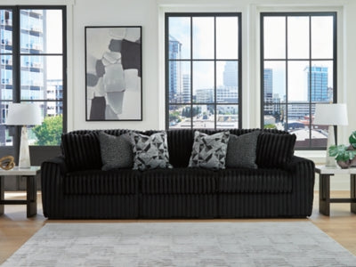 Ashley Furniture Midnight-Madness sectional sofa with plush cushions and modern design, shown in a cozy living room setting.