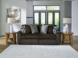 Ashley Furniture Midnight-Madness sectional sofa with dark upholstery, plush cushions, and modern design, shown in a cropped image.