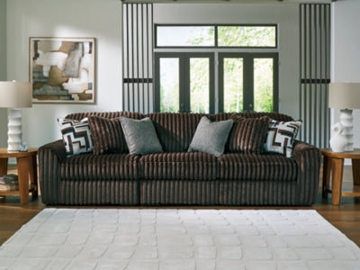 Ashley Furniture Midnight-Madness sectional sofa with plush cushions and modern design, shown in a cozy living room setting.