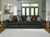 Ashley Furniture Midnight-Madness sectional sofa with plush cushions and modern design, shown in a cozy living room setting.