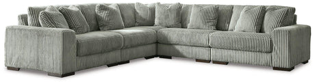 Ashley Furniture Lindyn sectional sofa with plush fabric and modern design, shown in a cozy living room setting.