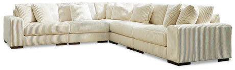 Ashley Furniture Lindyn sectional sofa with plush cushions and modern design, shown in a cozy living room setting.