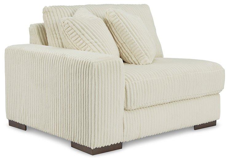 Ashley Furniture Lindyn sectional sofa with plush cushions and modern design, shown in a cozy living room setting